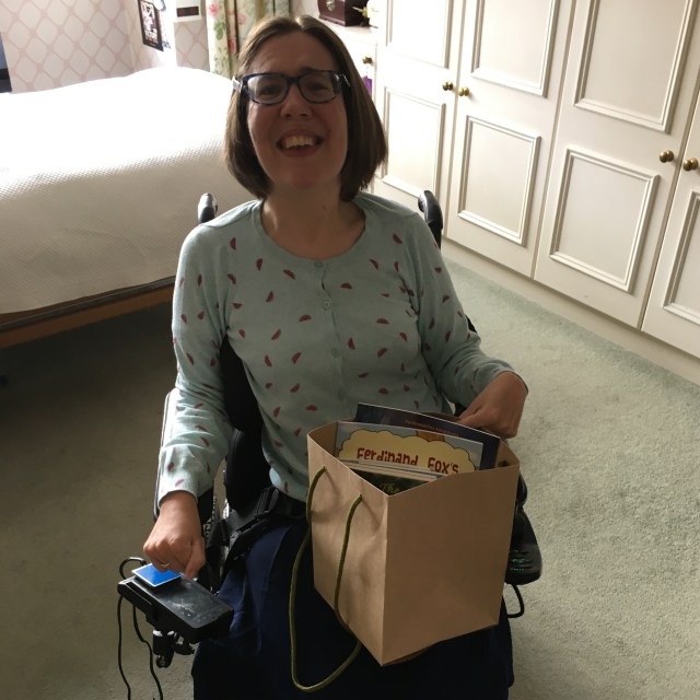 Image of Becky Butler holding signed children's books from Karen Inglis